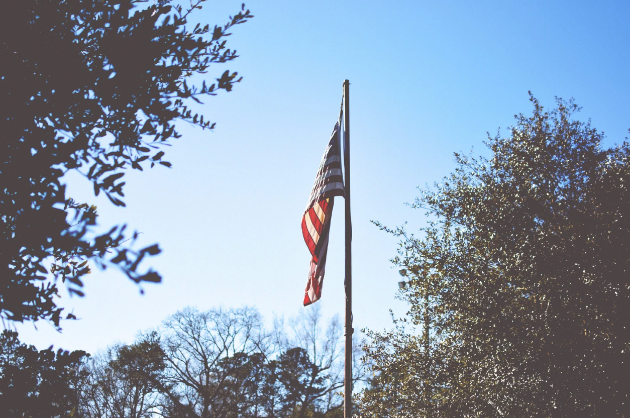 American Flag at dawn with the sky as background