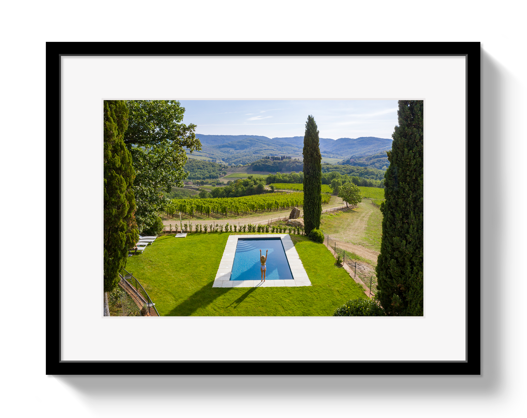 Framed photograph of a pool with a scenic landscape in the background