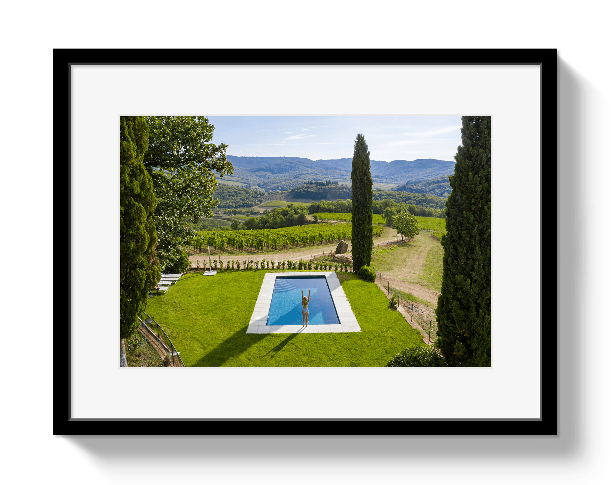 Framed photograph of a pool with a scenic landscape in the background