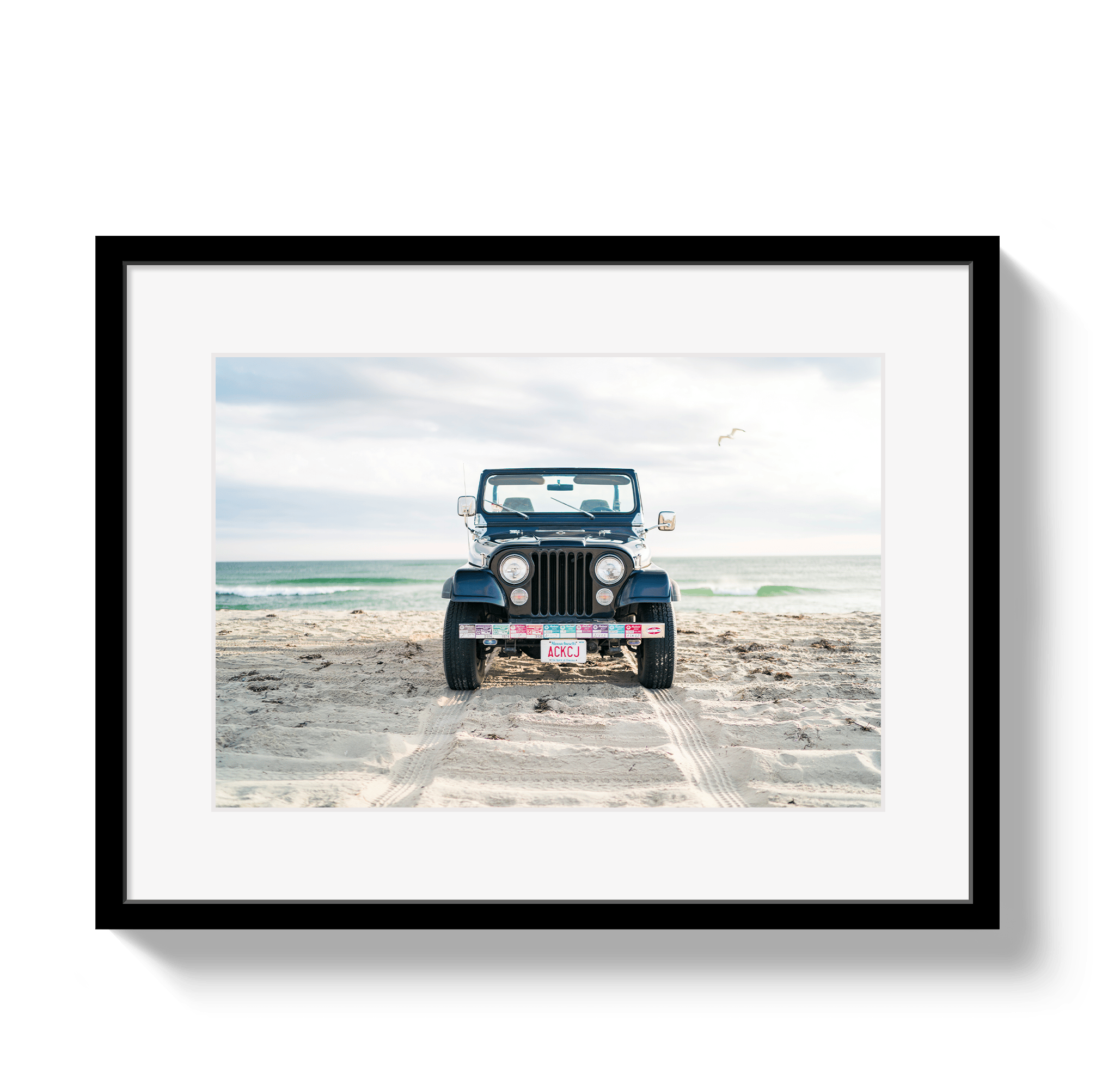 Framed photo of a blue jeep on a beach