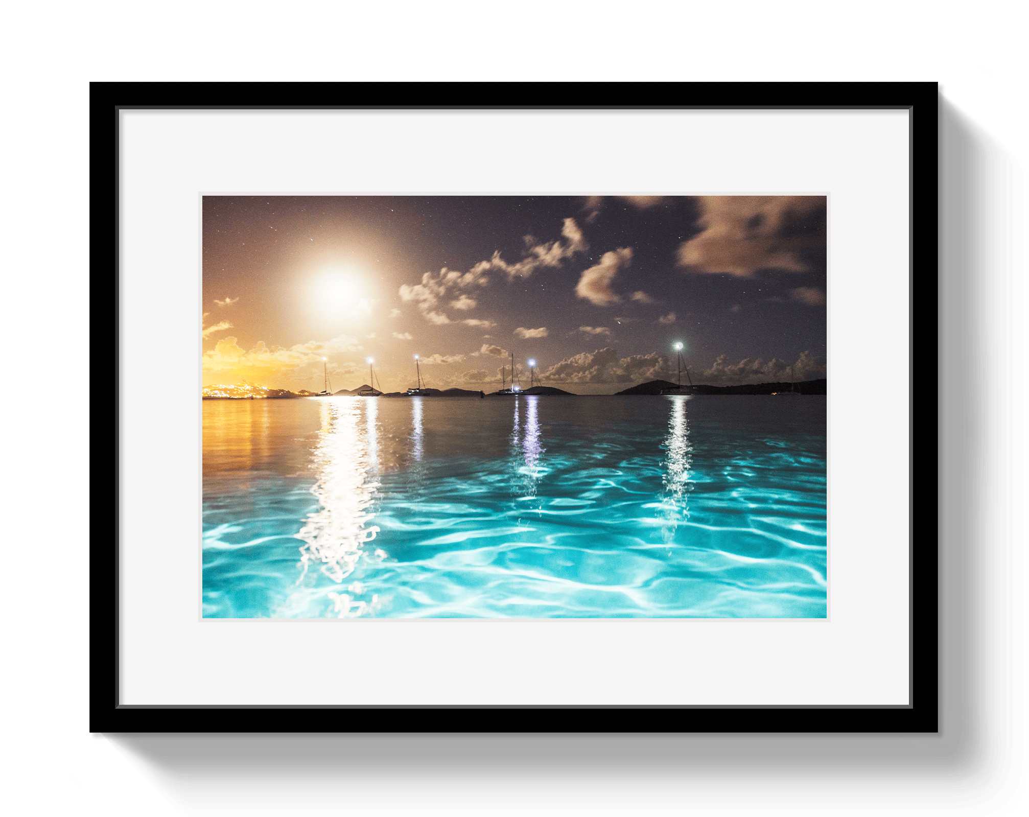 Framed artwork of a sunset over water with a black frame.