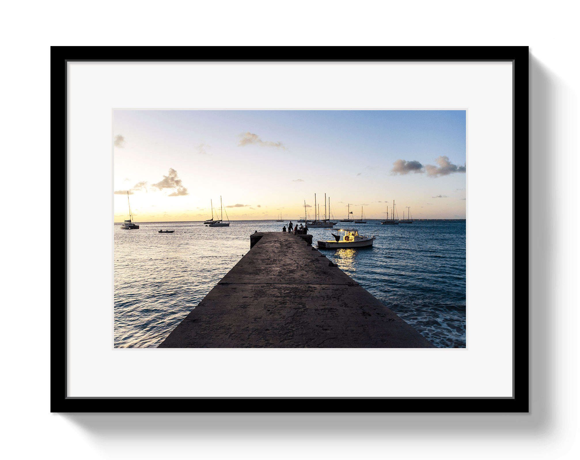 Framed photograph of a dock with boats at sunset.