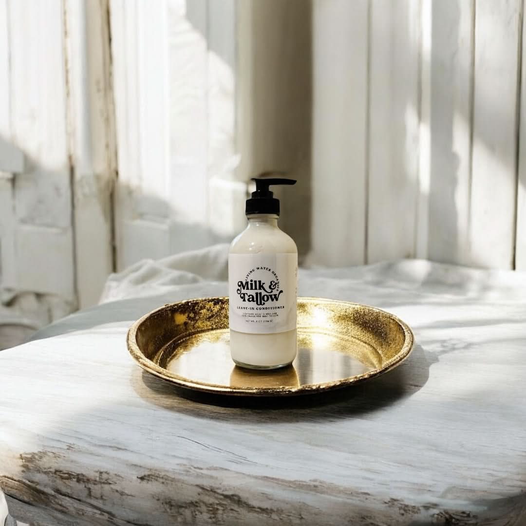 Milk & Hallow bottle on a gold tray with a marble surface and curtain background