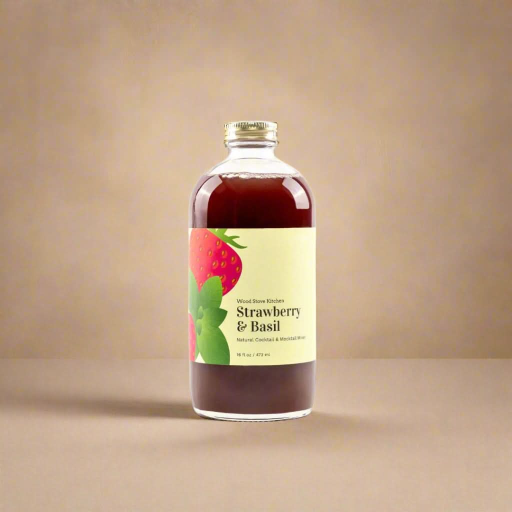 Bottle of strawberry and basil-flavored liquid on a white background
