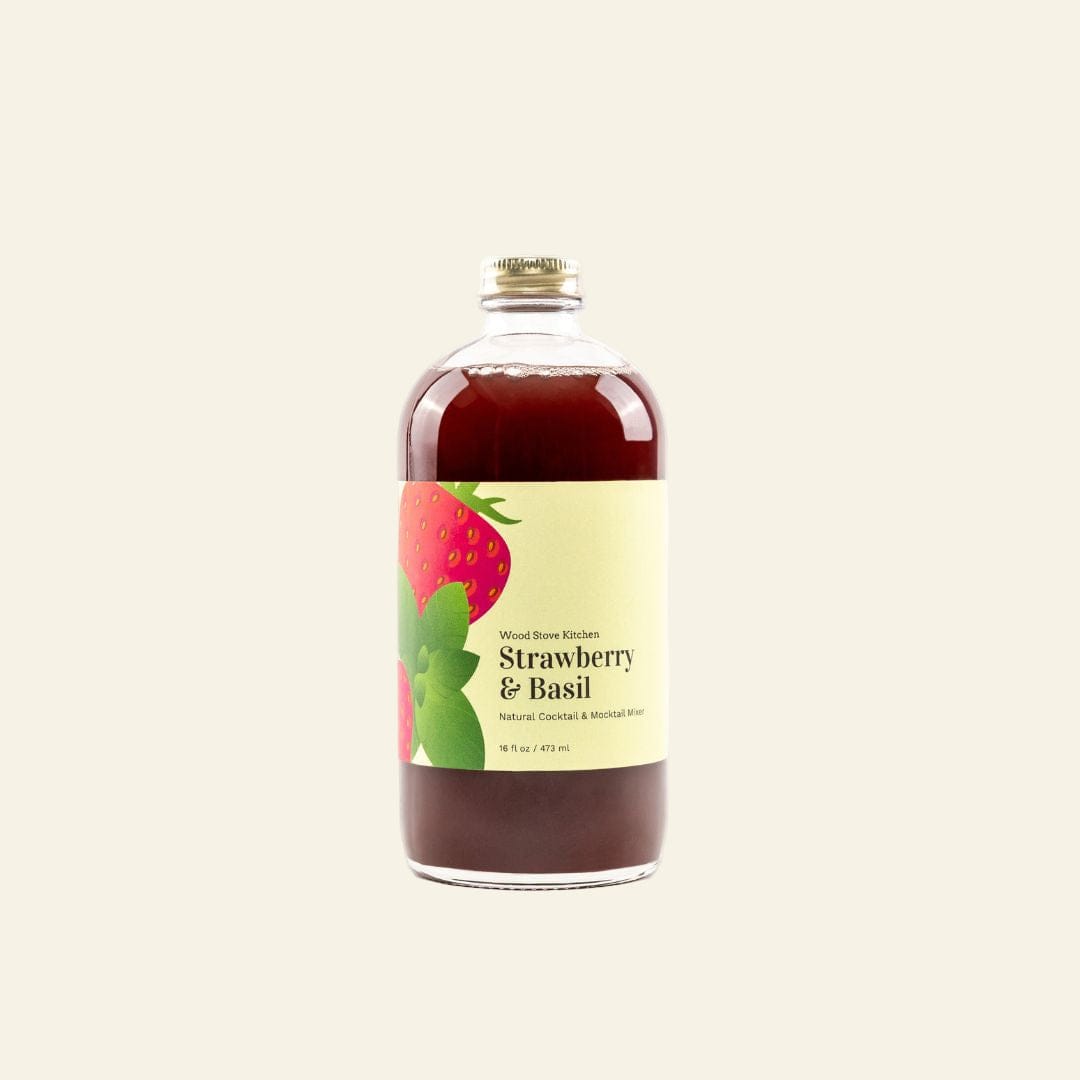 Bottle of strawberry and basil-flavored liquid on a white background