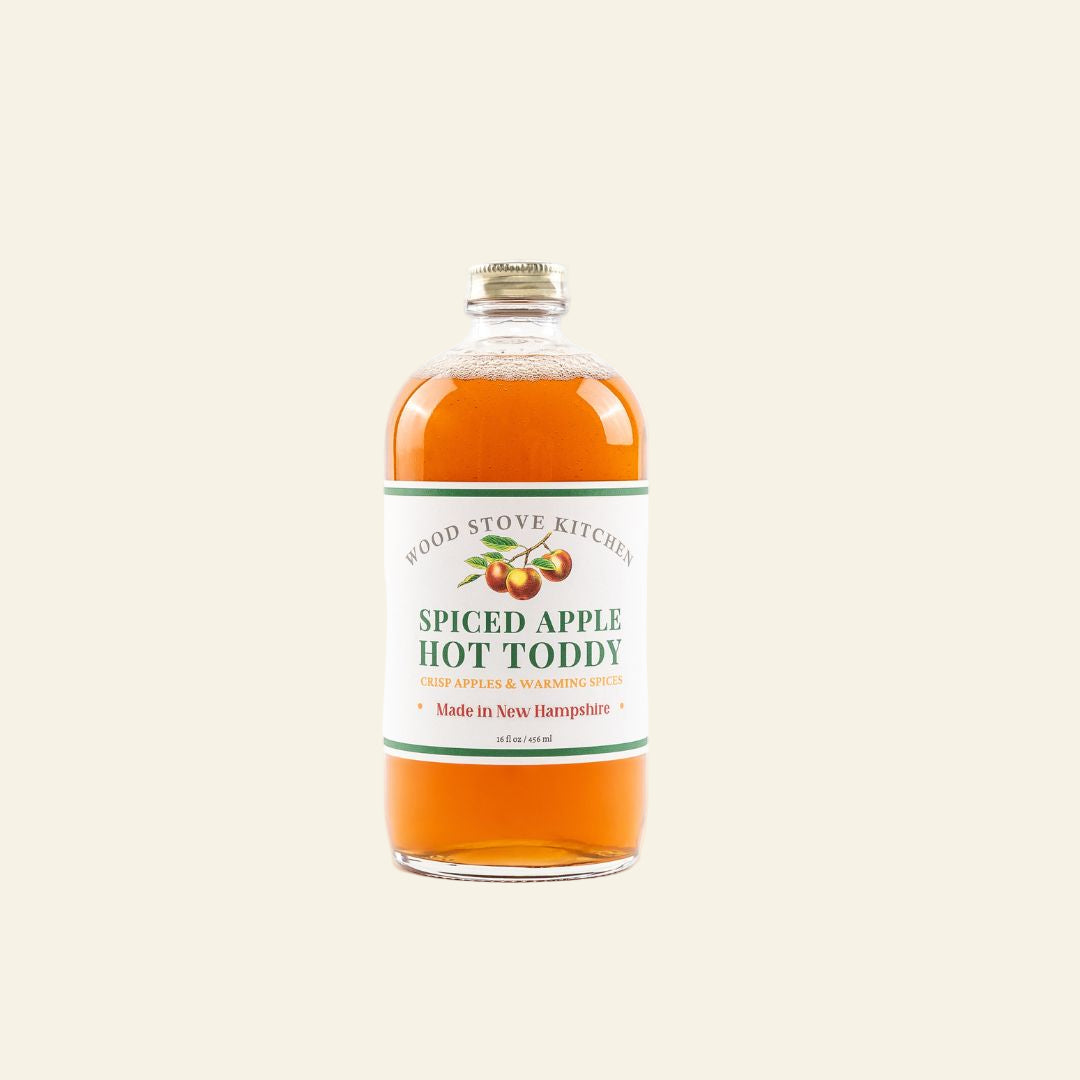 Bottle of spiced apple hot toddy with a label on a white background