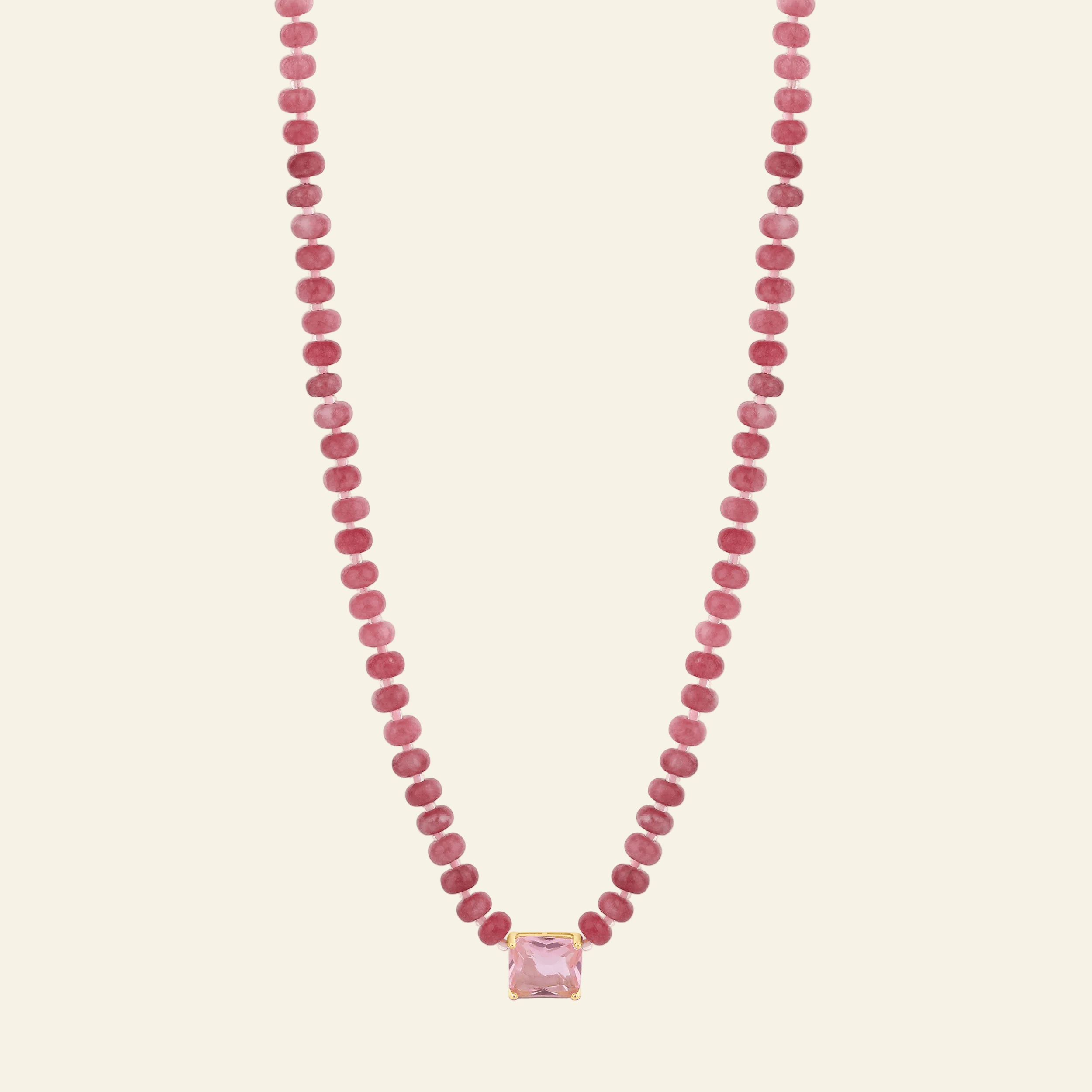 Necklace with pink beads and a pink pendant on a white background