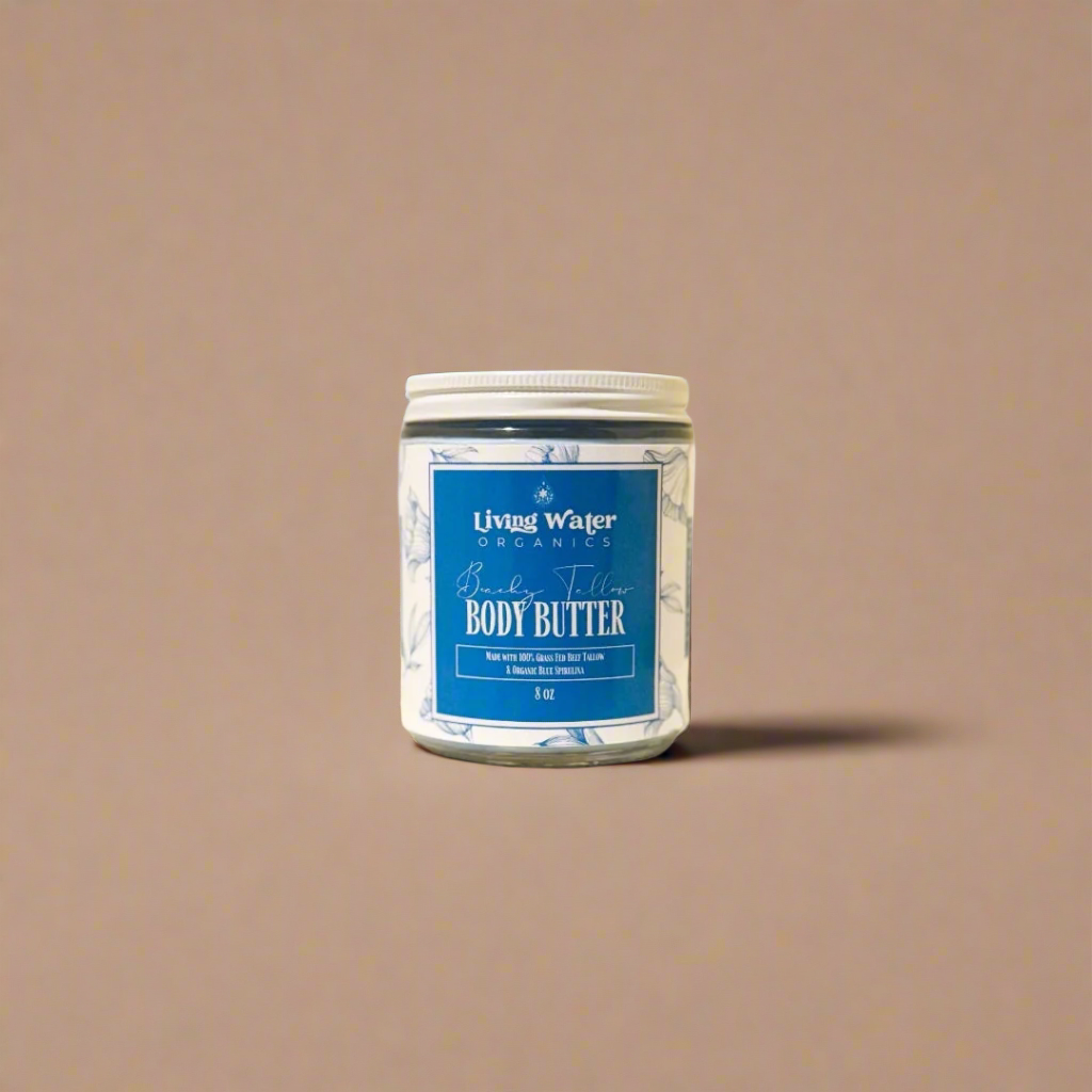 Jar of body butter with a blue label on a beige background