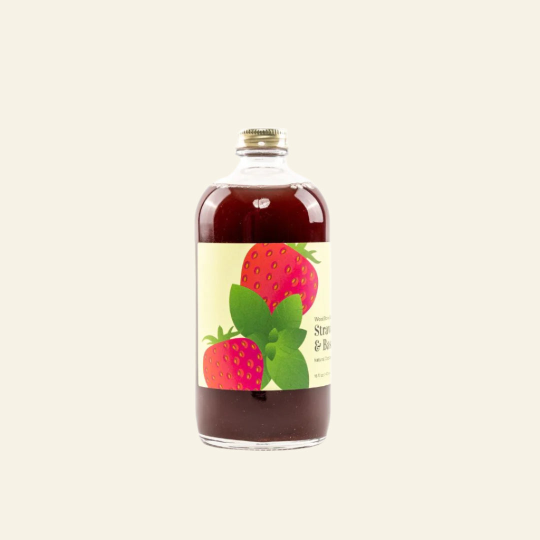 Bottle of syrup with a strawberry label on a white background