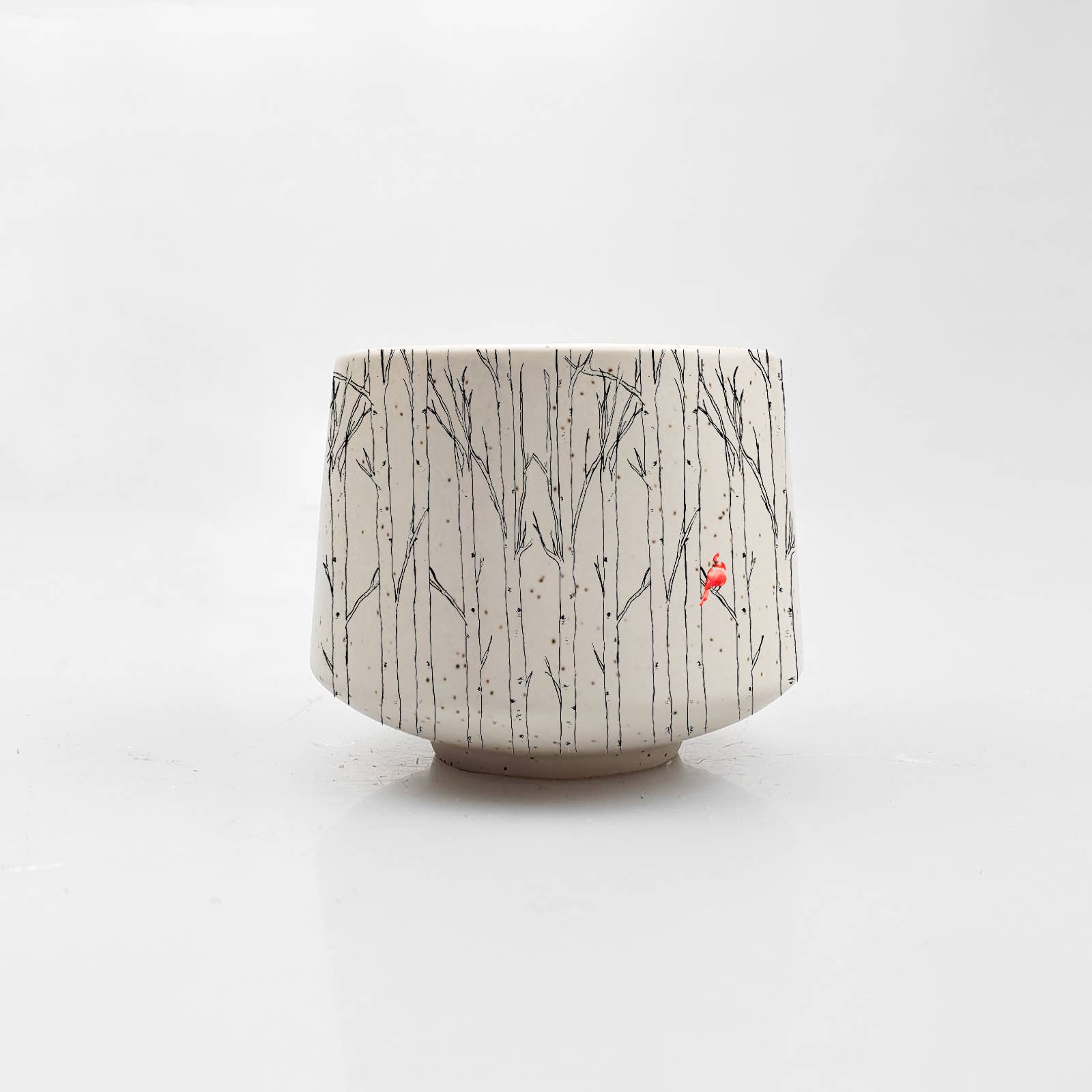 Ceramic pot with tree pattern on a white background