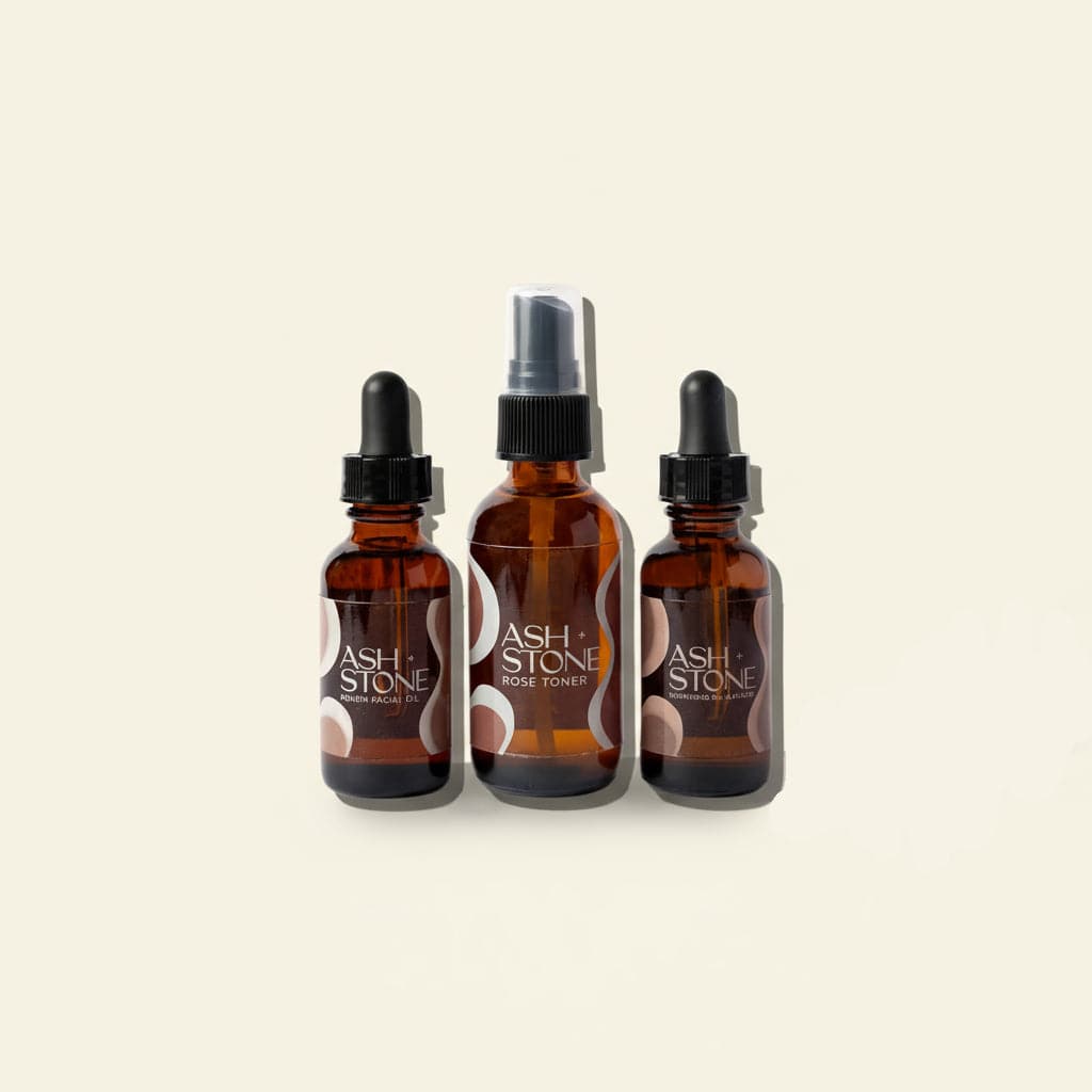 Three brown glass bottles with black caps labeled &