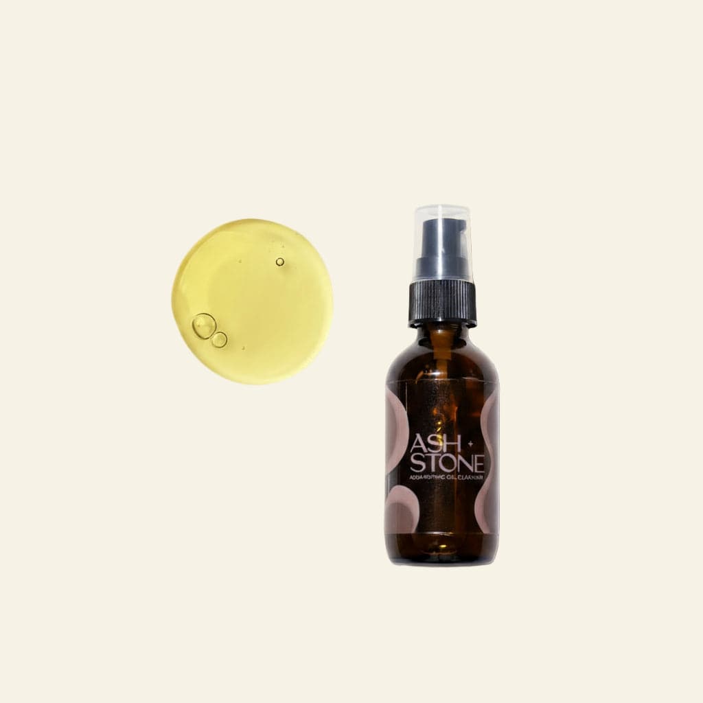 Brown glass bottle with spray nozzle and yellow circular product on a white background