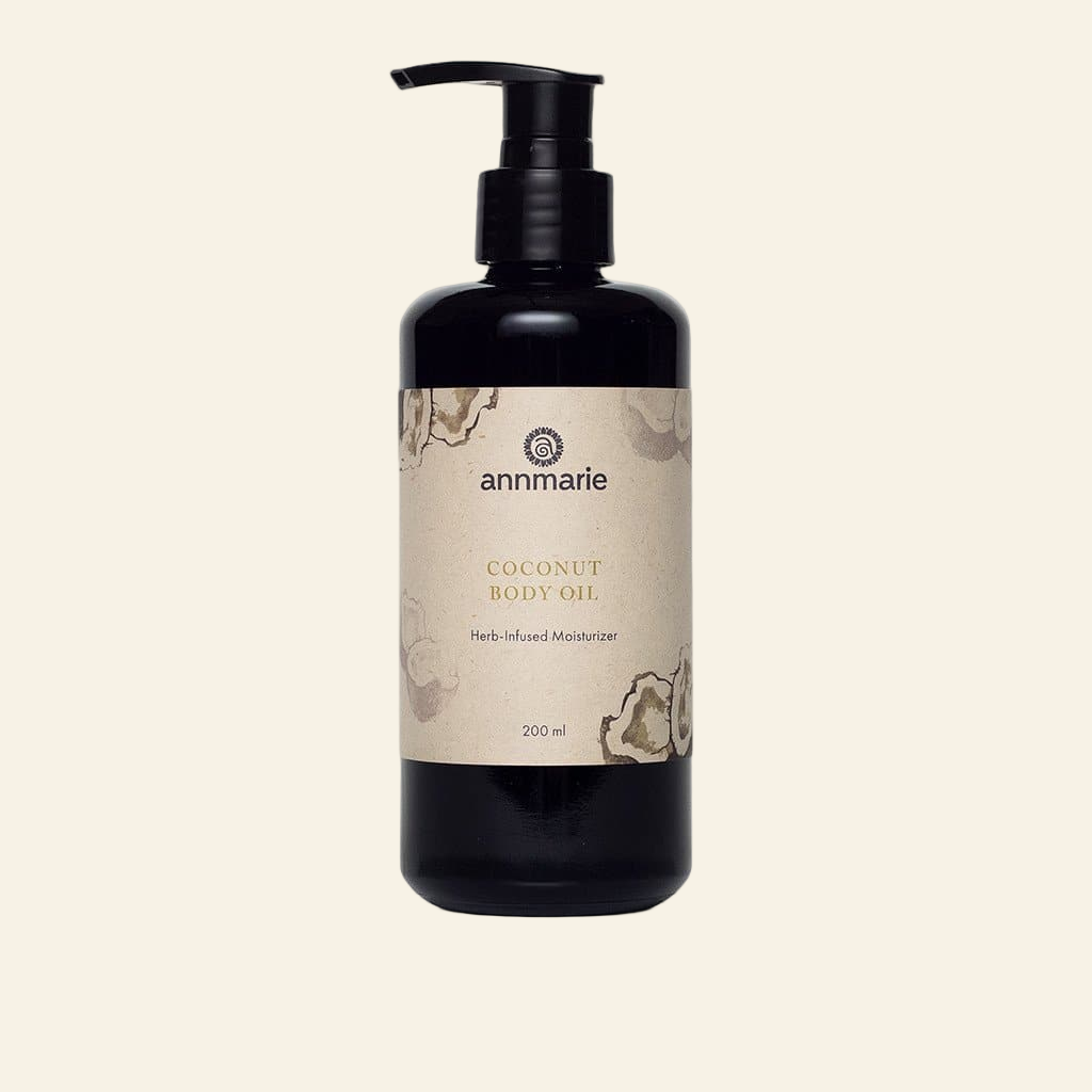 Coconut body oil bottle with a beige label on a white background