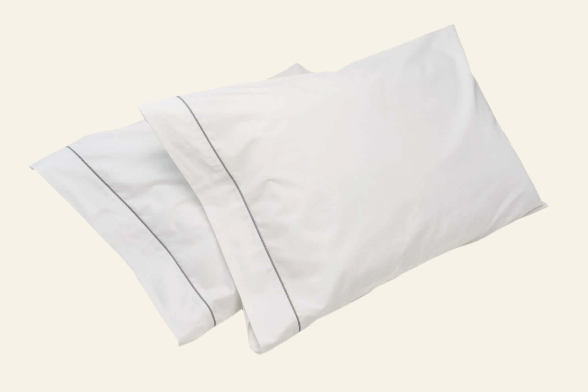 Set of white pillowcases on a light gray background