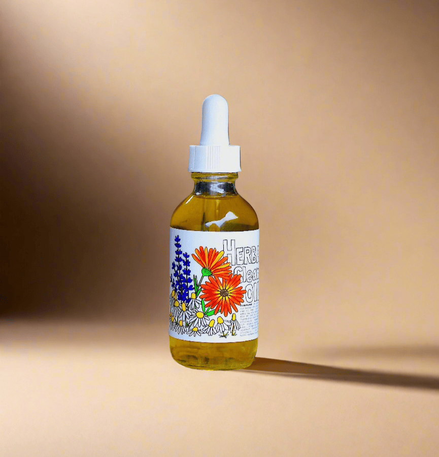 Bottle of herbal tincture with a dropper on a sandy surface