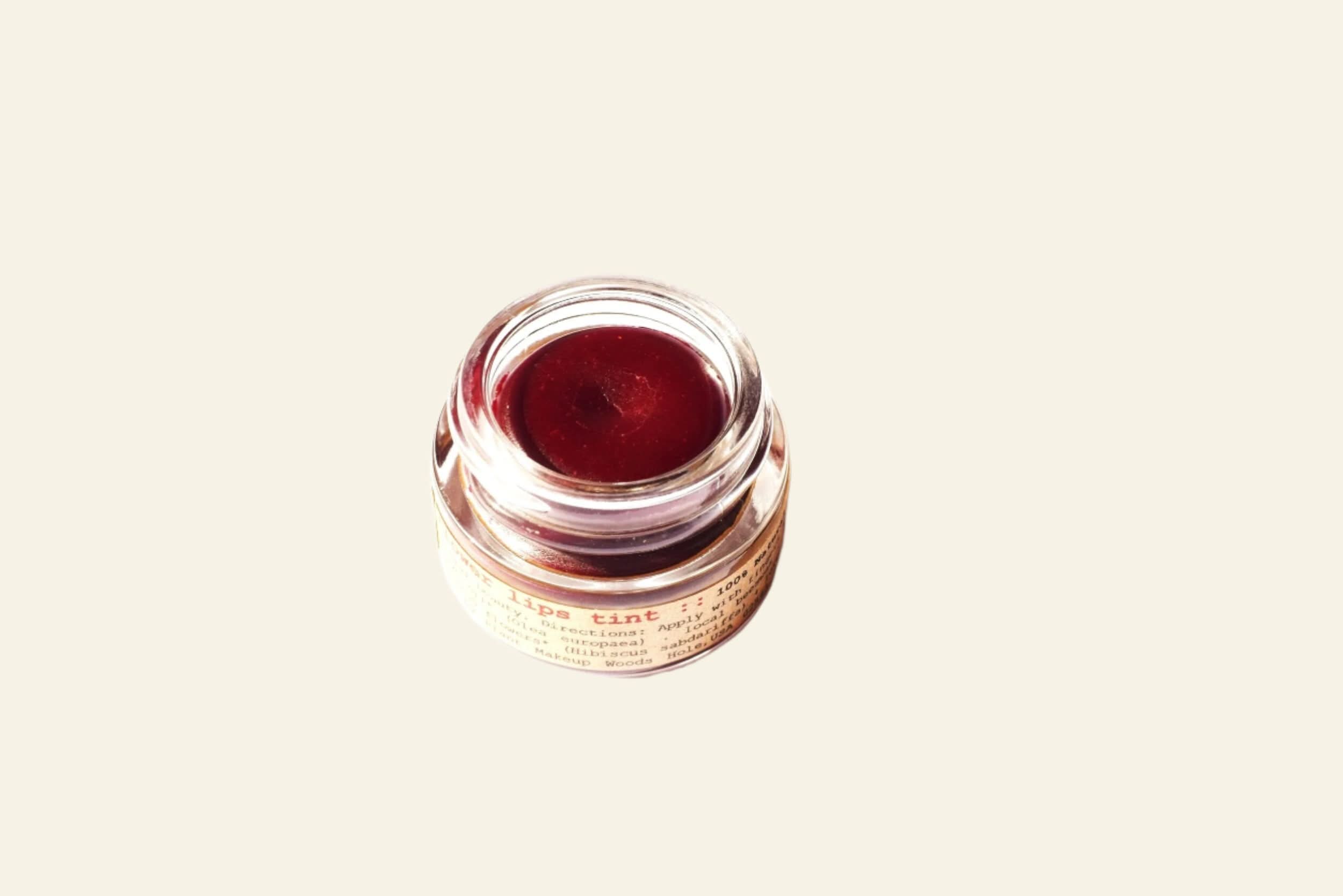 Jar of red cream on a white background