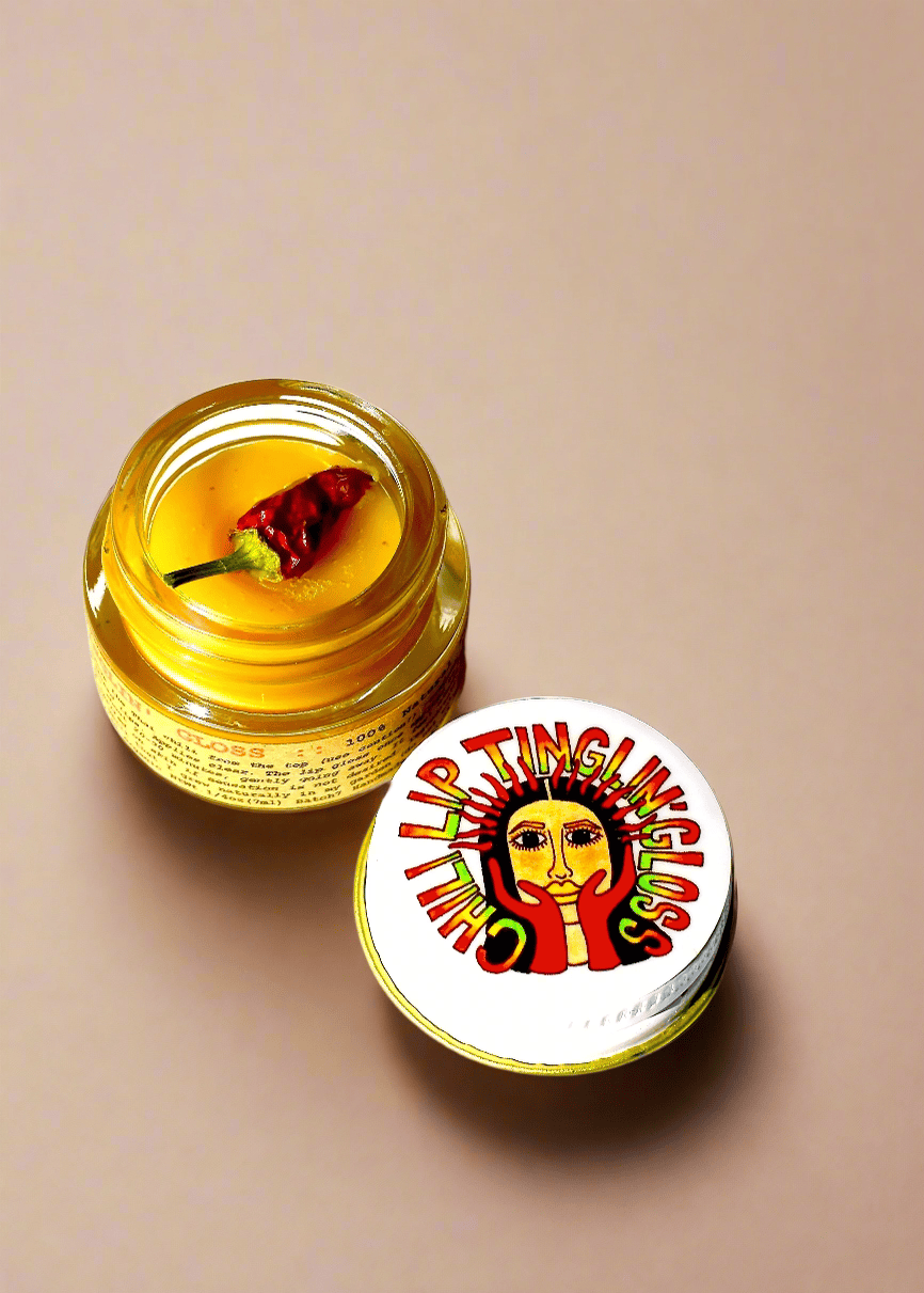 Open jar of lip balm with a red chili pepper on a beige background