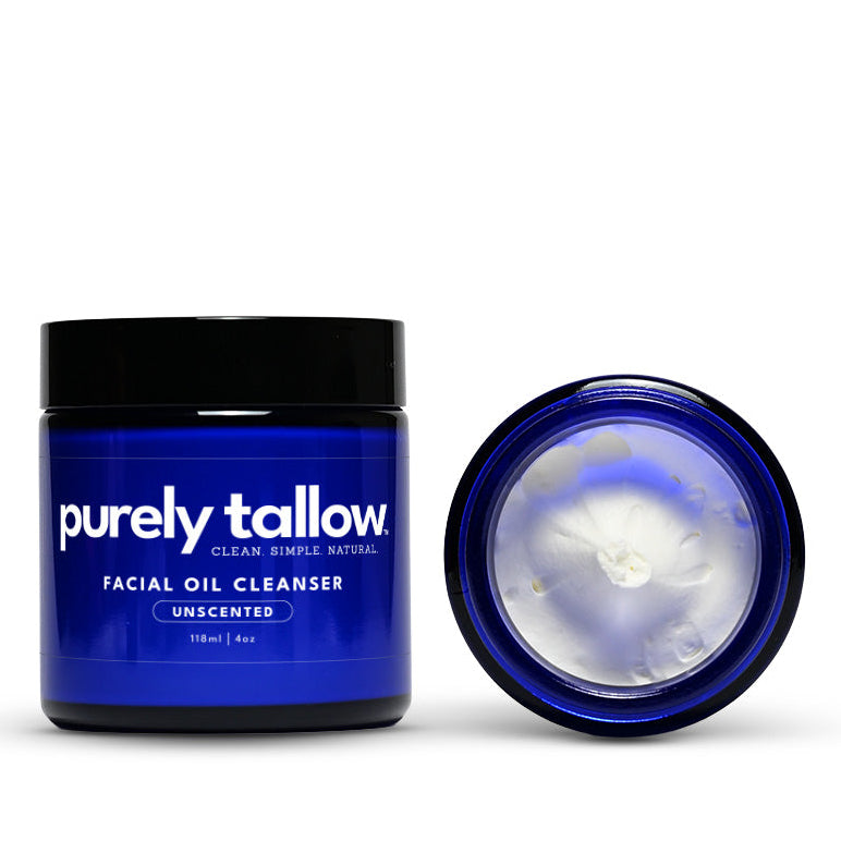 Blue facial oil cleanser jar with black lid on a white background
