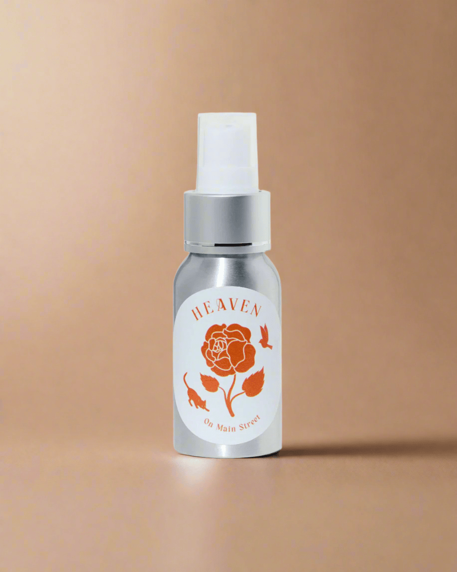 Silver bottle with a white label featuring a rose design on a light gray background