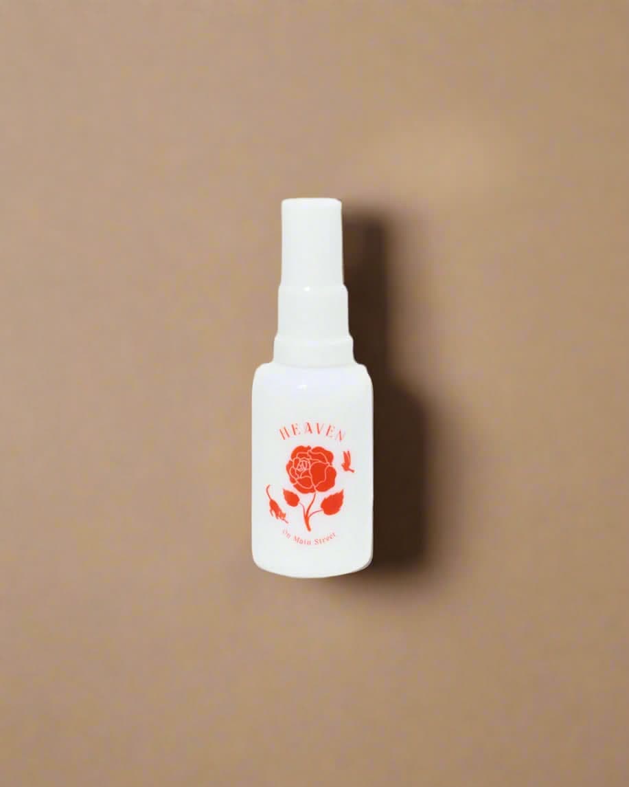 White bottle with red rose design on a white background