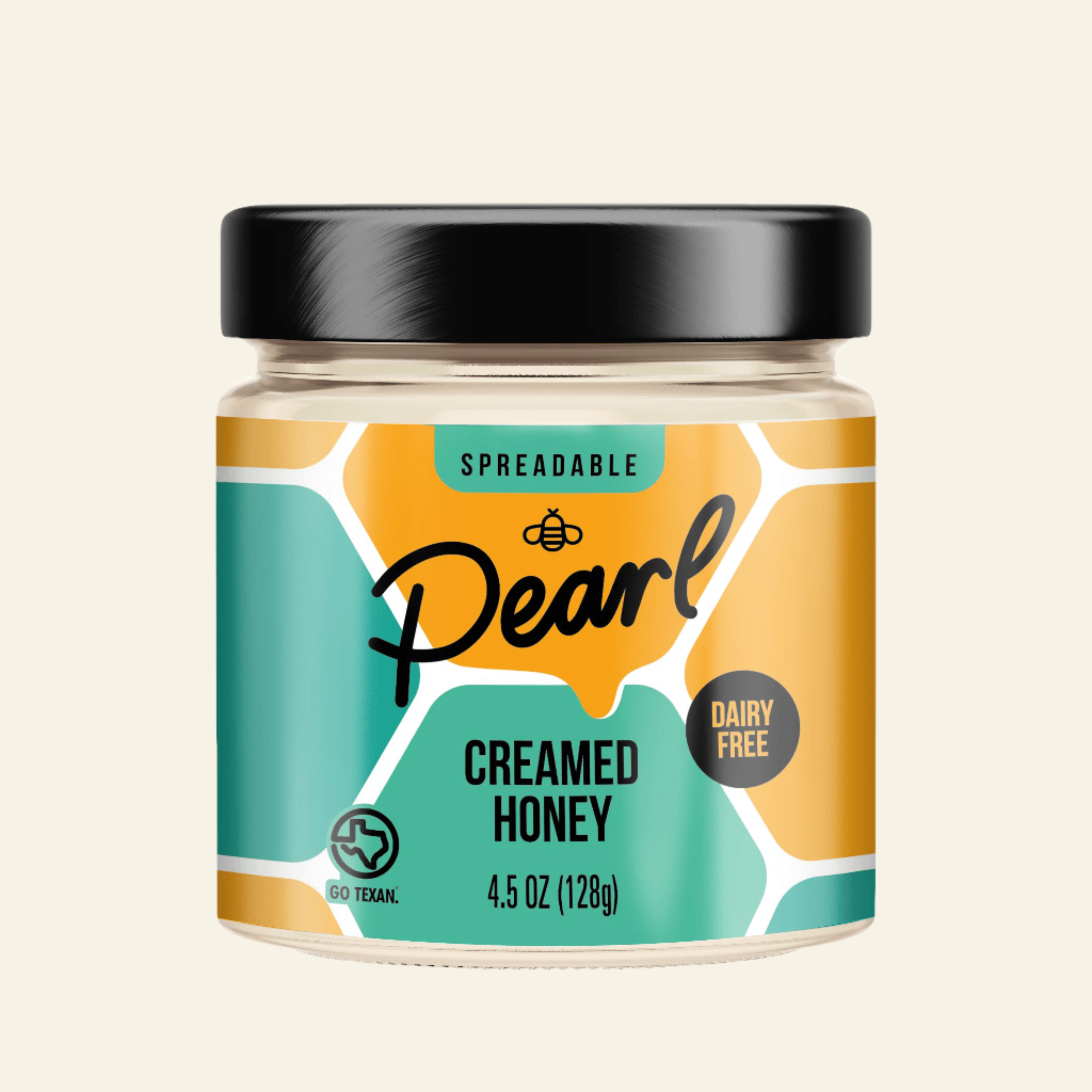 Jar of Pearl Creamed Honey with a black lid on a white background