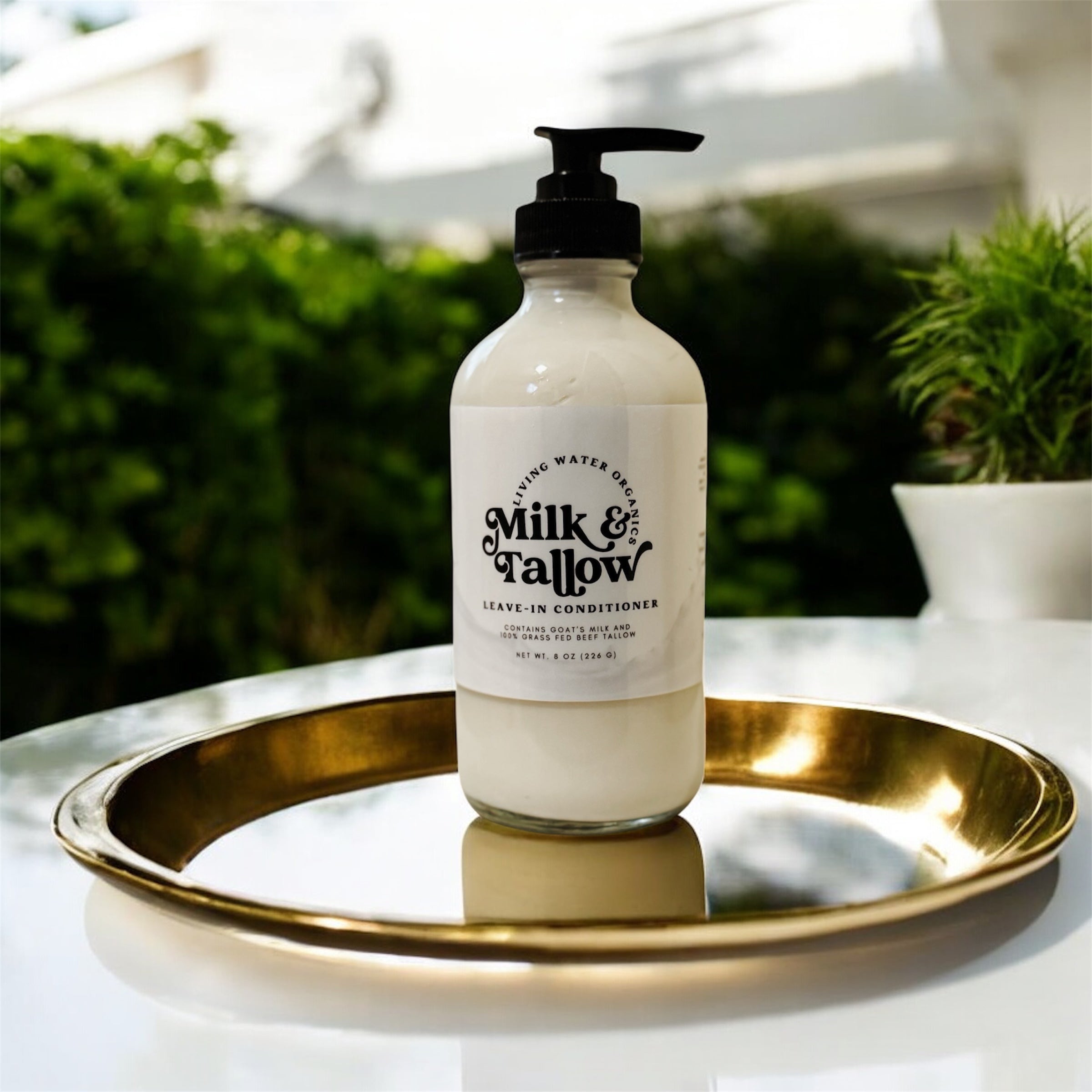Bottle of Milk & Fallow conditioner on a gold tray with a blurred outdoor background