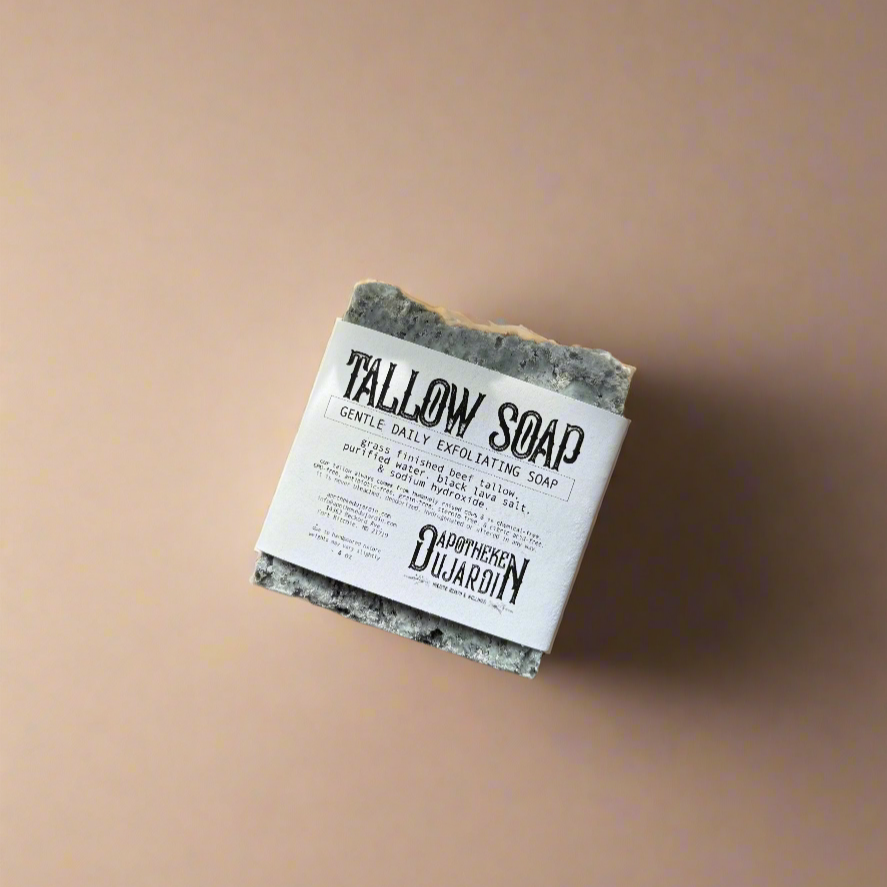 Bar of soap with a label on a beige background