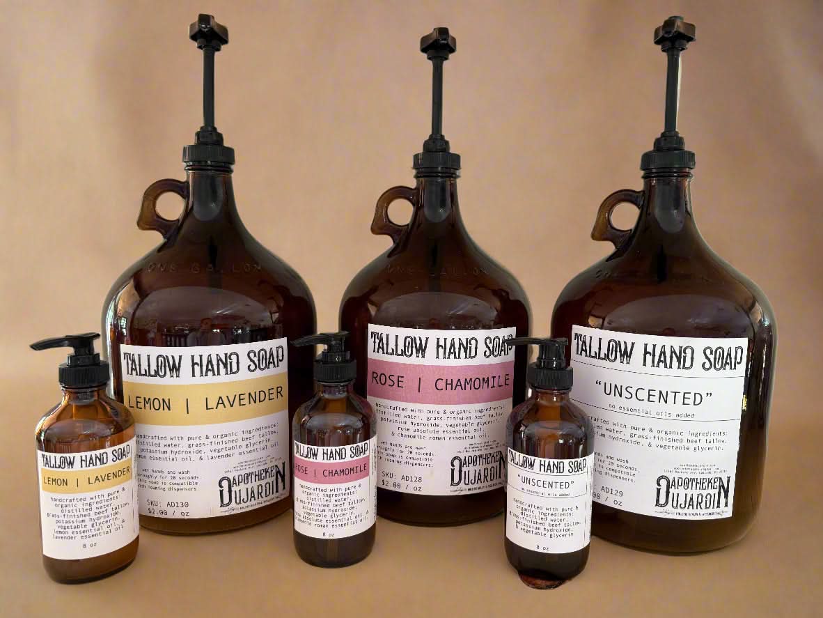 Collection of Dularin hand soap bottles on a wooden surface with a neutral background.