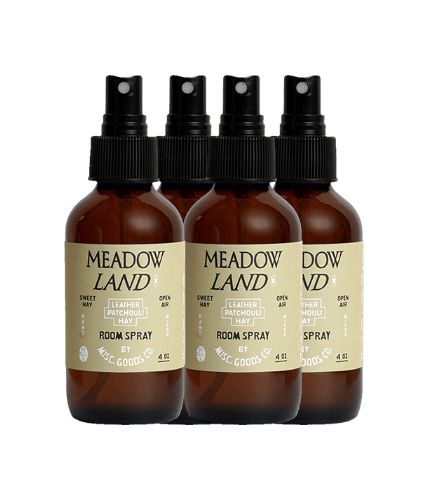 Four bottles of Meadow Land room spray on a white background