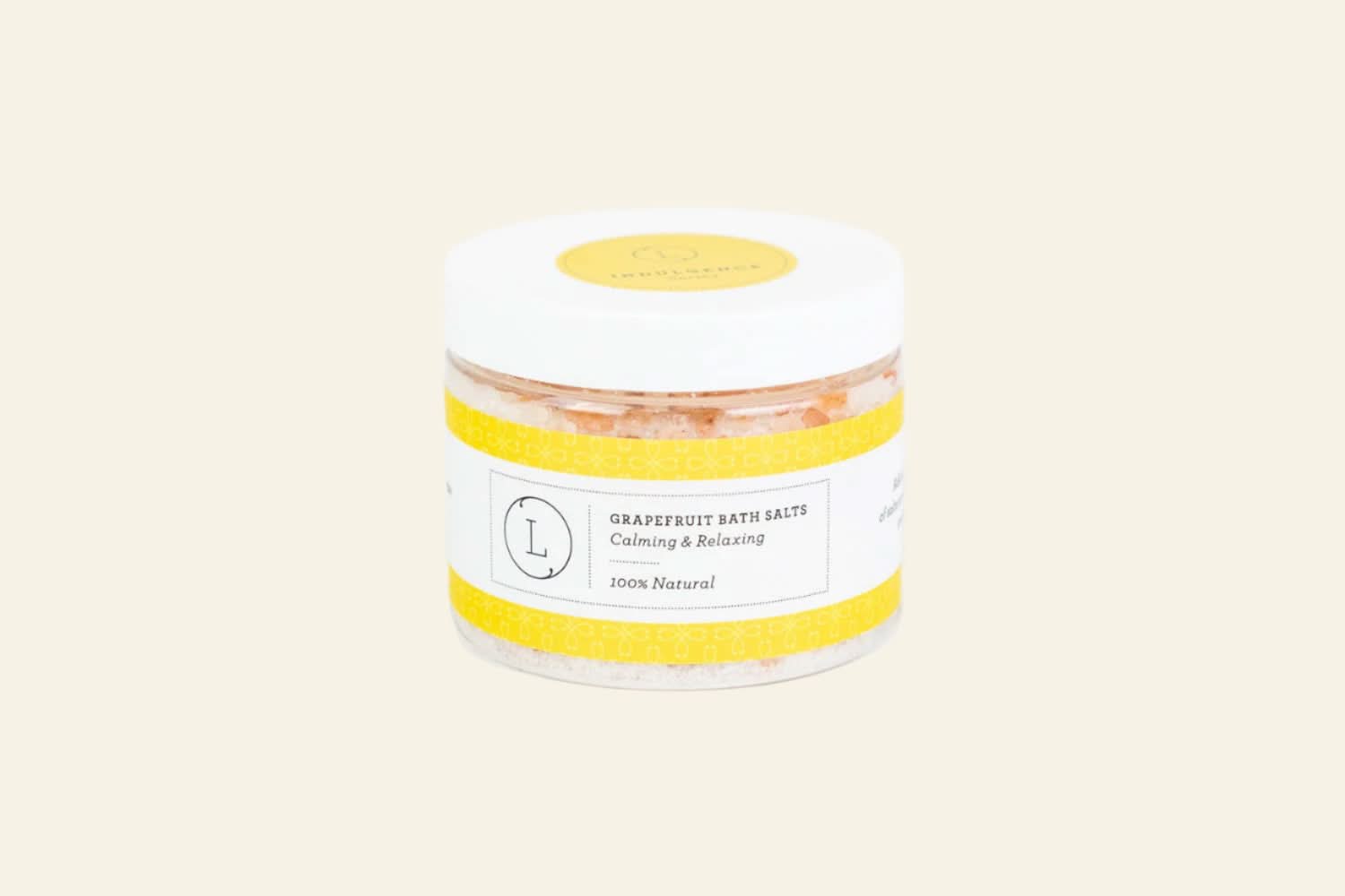 Jar of grapefruit bath salts with a yellow label on a white background