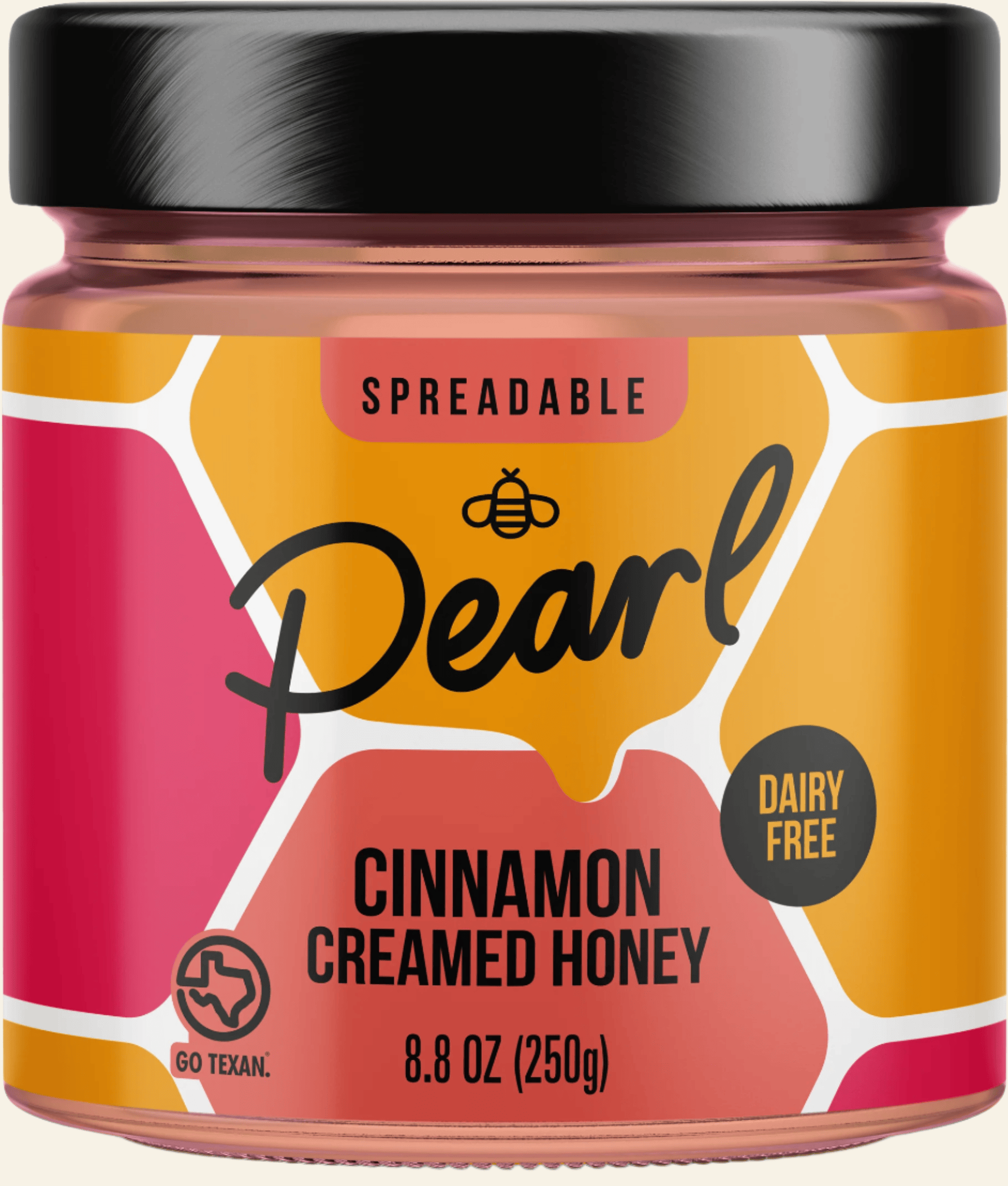 Jar of Pearl Cinnamon Creamed Honey with a black lid on a white background