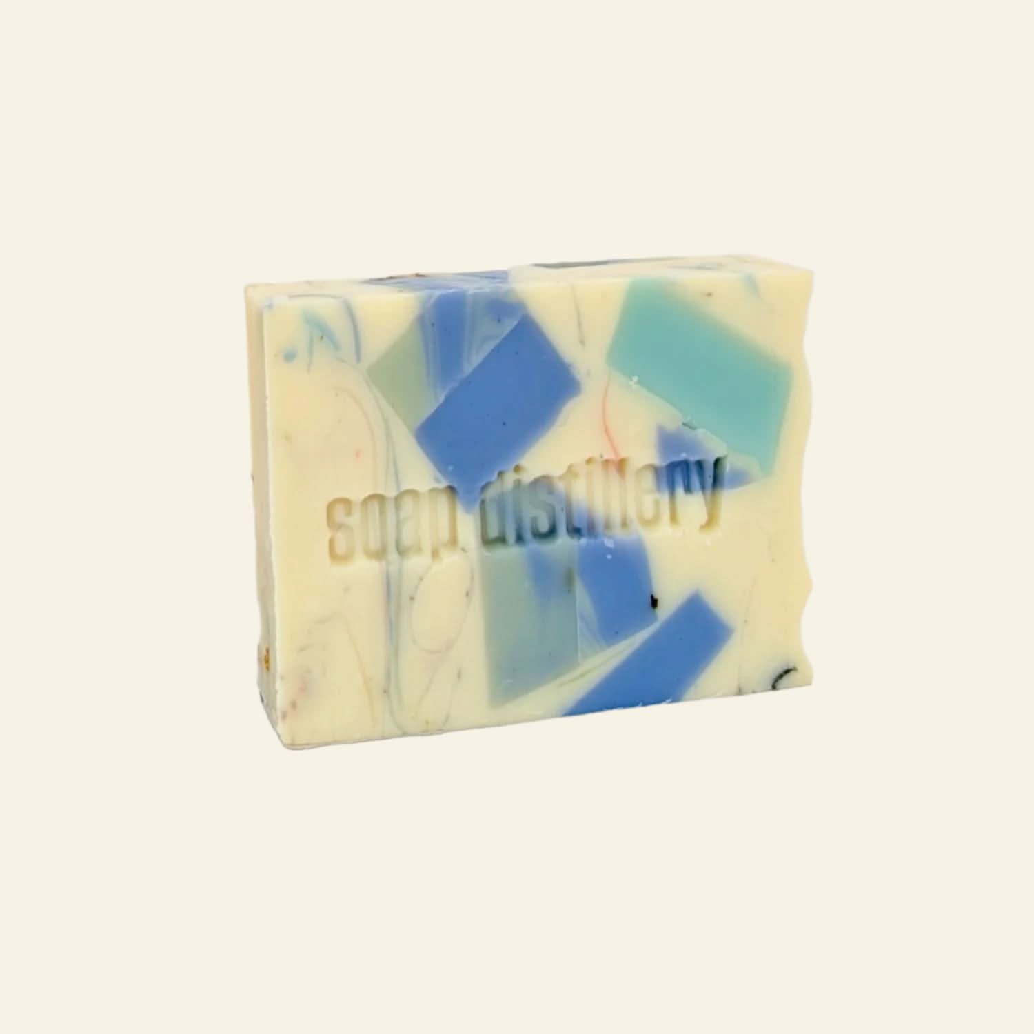 Bar of soap with blue and green swirls on a white background