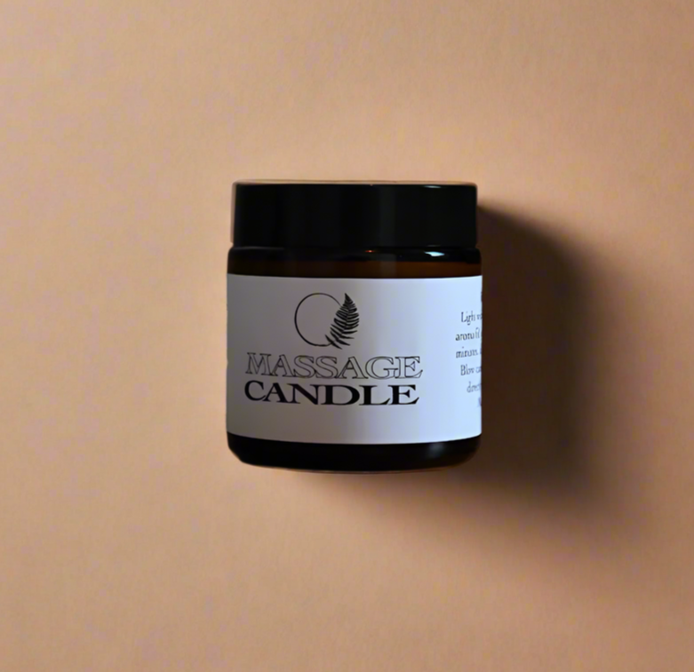 Jar of massage candle on a wooden surface with a blurred background