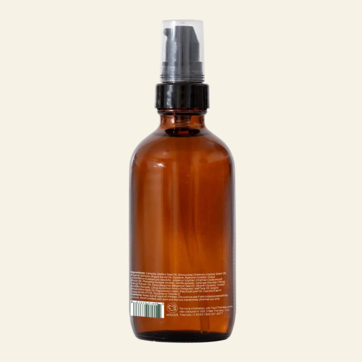 Brown glass bottle with black spray nozzle on a white background