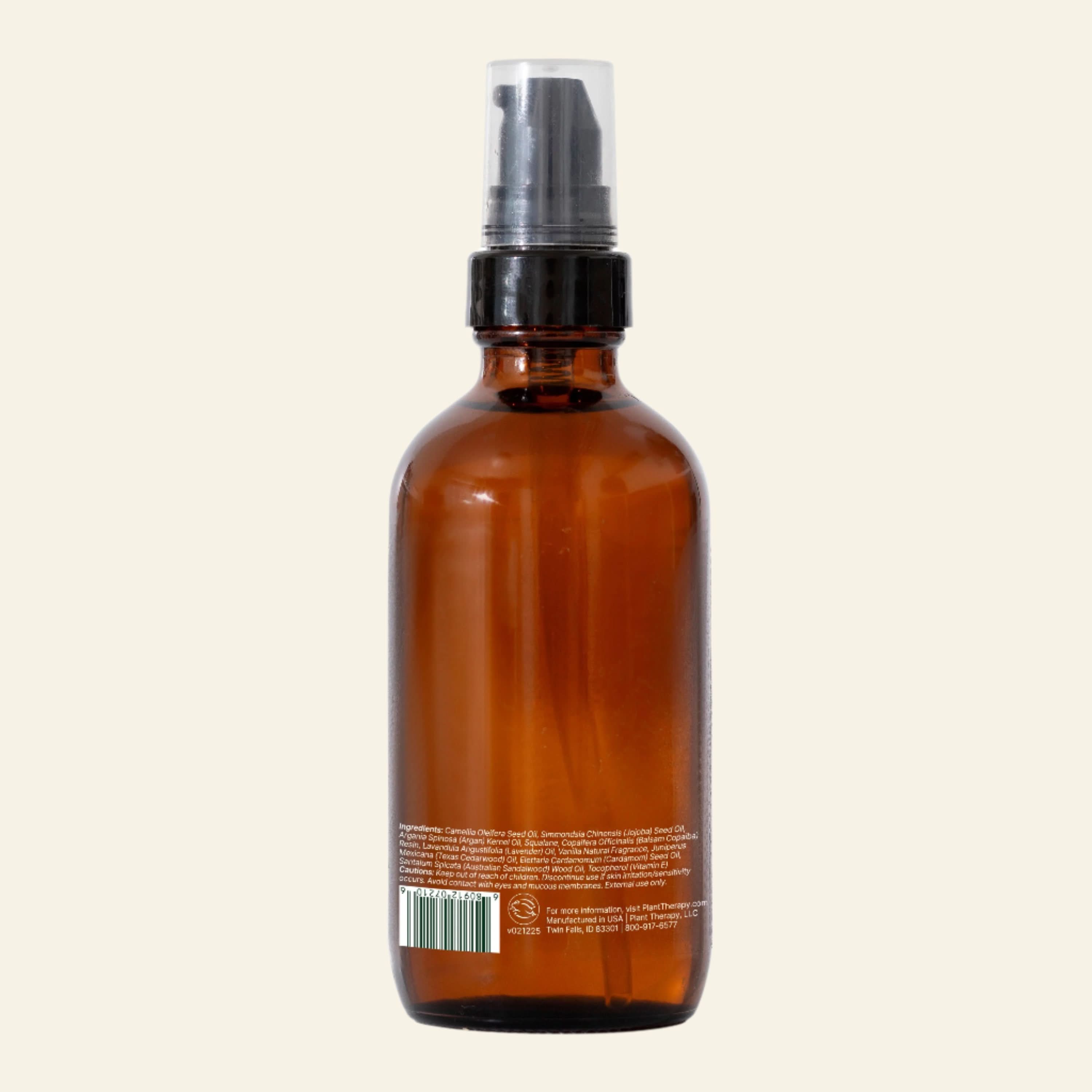 Brown glass bottle with black spray nozzle on a white background