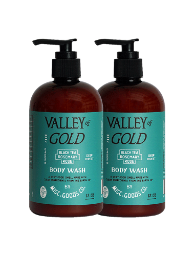Two bottles of Valley of Gold body wash with pump dispensers on a white background.