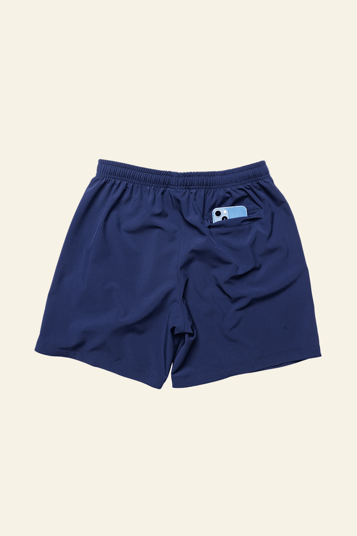 Navy blue shorts with a small logo on a white background