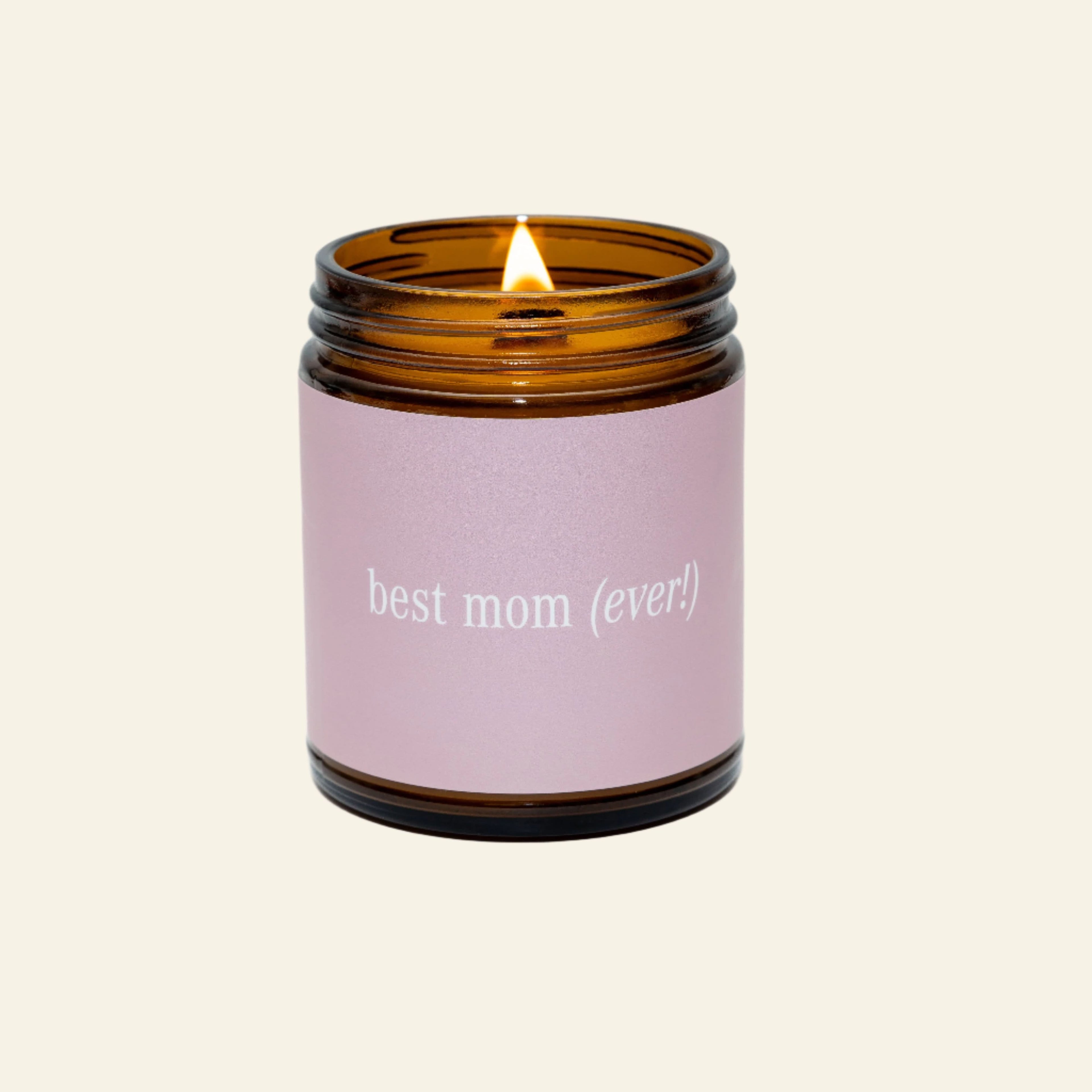 Candle in an amber jar with a pink label reading &