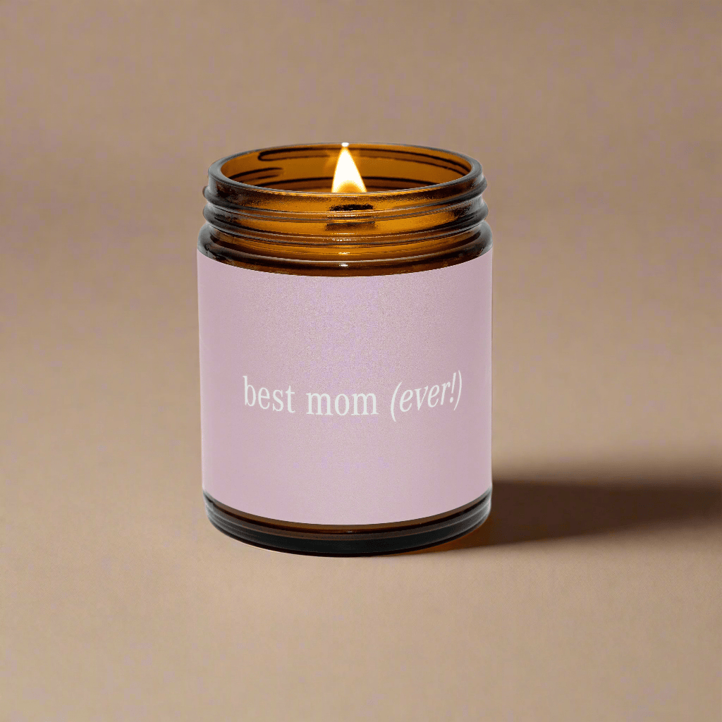Candle in an amber jar with a pink label reading &