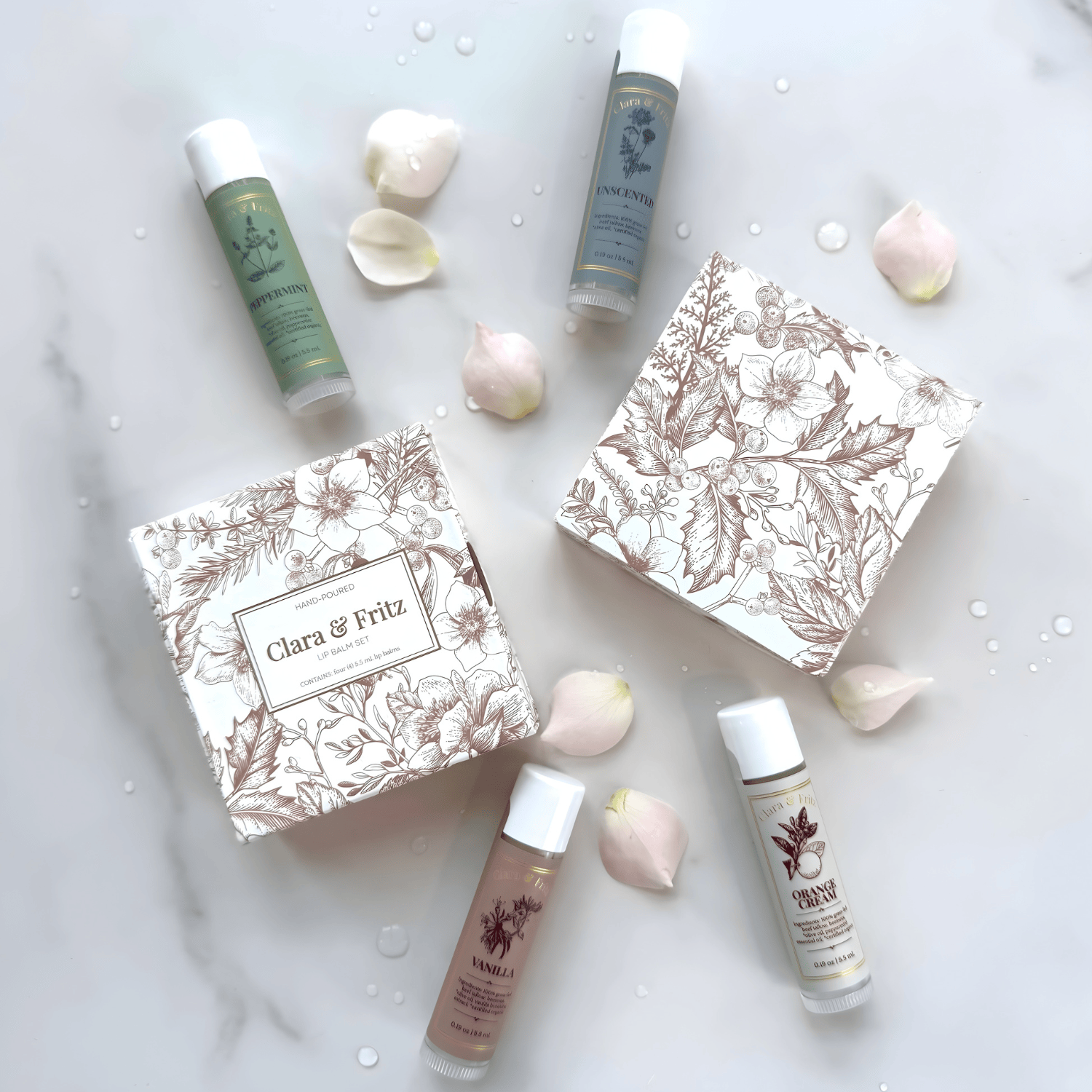 Cosmetic products with floral packaging and white bottles on a light background