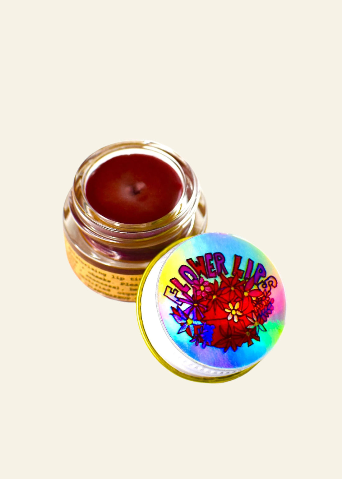 Lip balm container with a colorful lid featuring floral designs on a white background