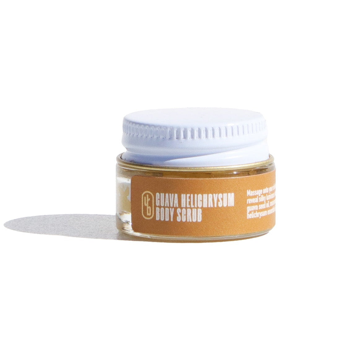 Jar of body scrub with a white lid on a white background