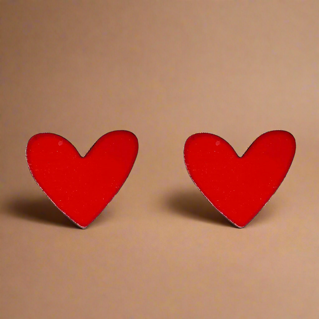 Red heart-shaped earrings on a white background