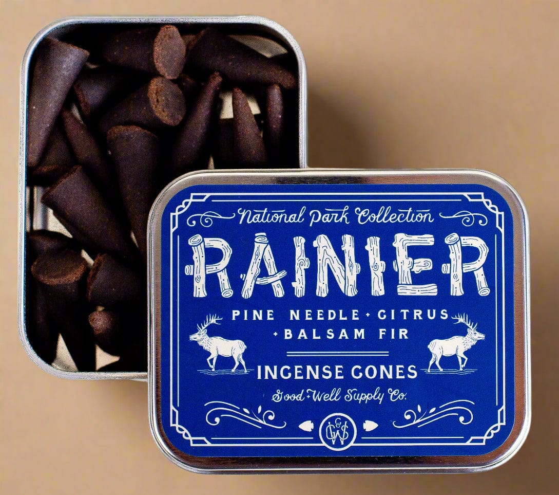 Tin of Rainier incense cones with a blue label featuring text and illustrations.