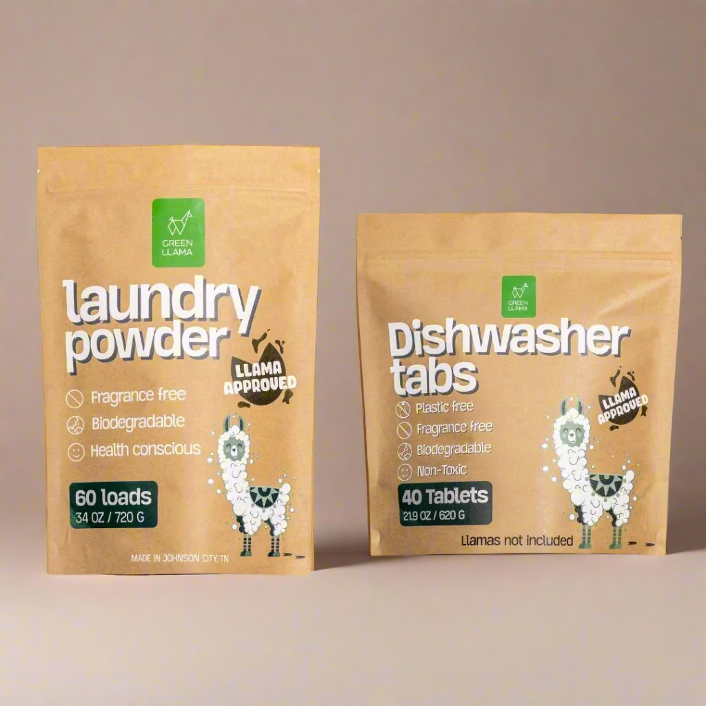 Two packages of laundry powder and dishwasher tabs with llama graphics on a beige background