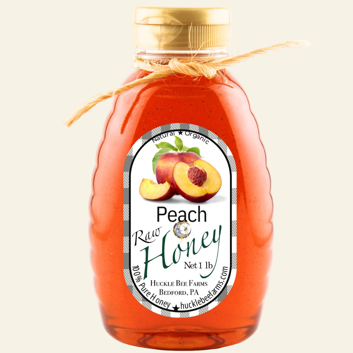 Bottle of peach honey with a label on a white background