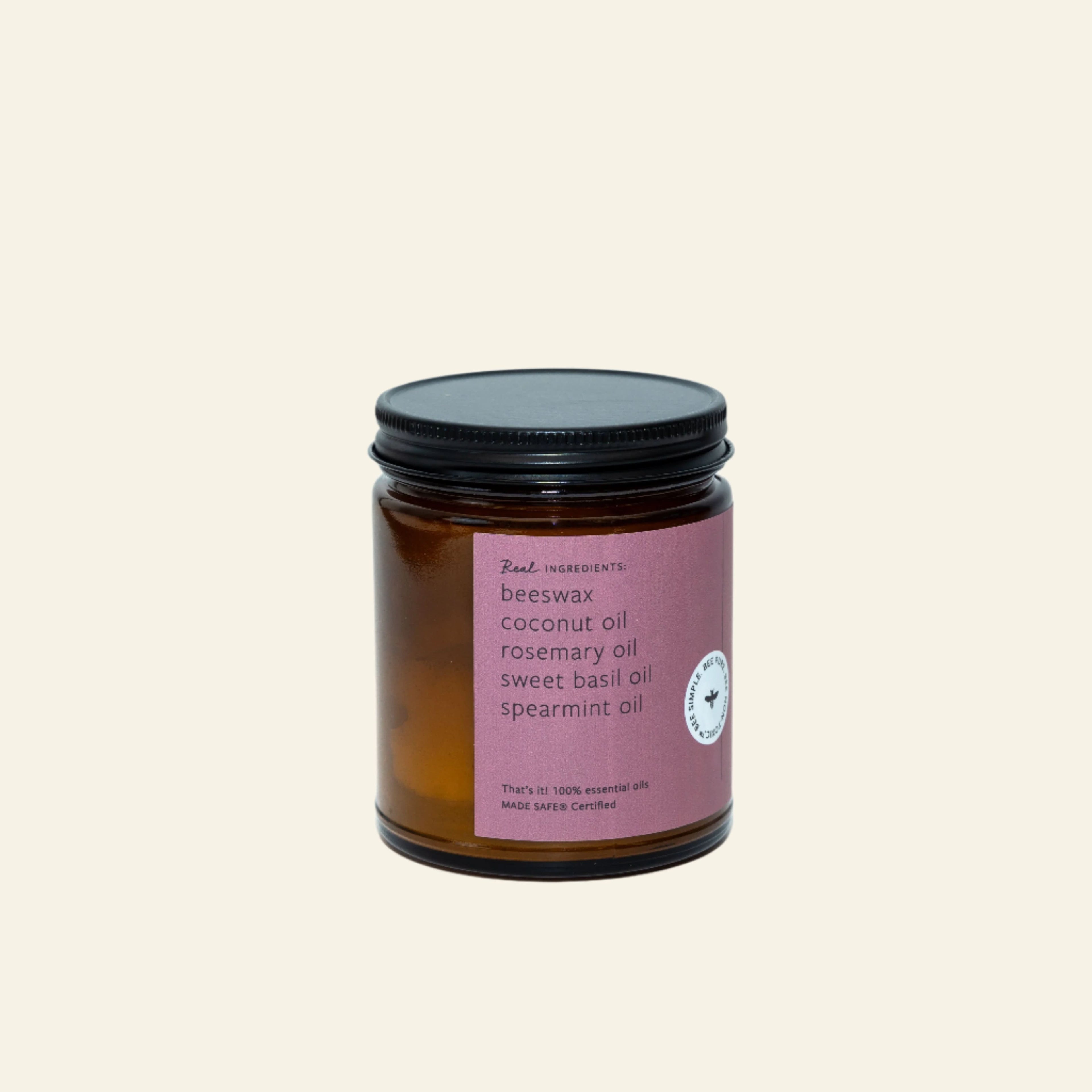 Amber candle jar with a black lid on a white background