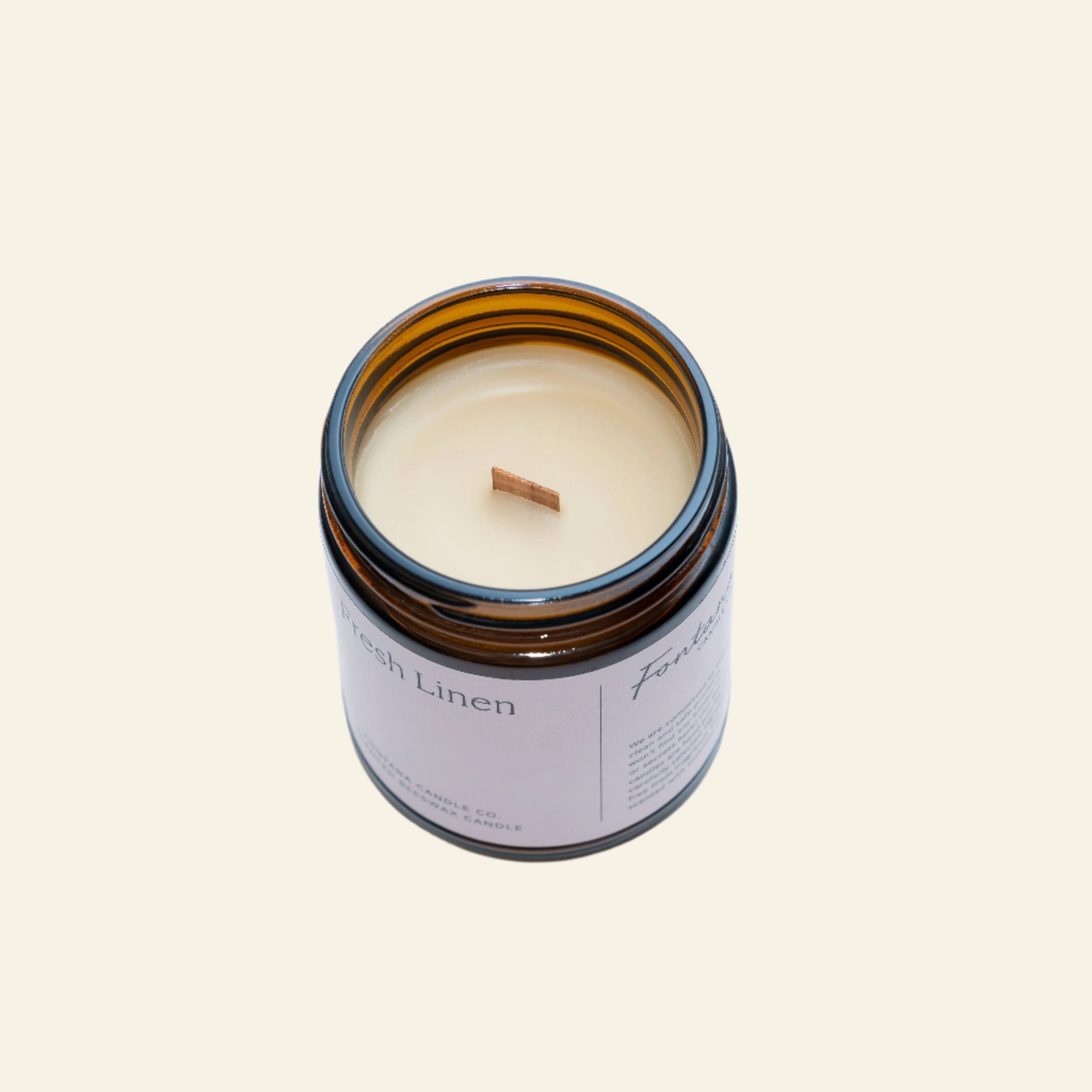 Candle in a glass jar with a label on a white background