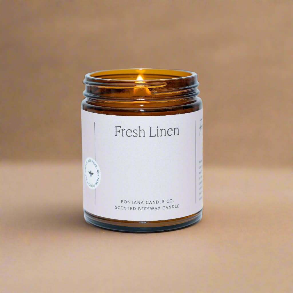 Candle in an amber jar labeled &