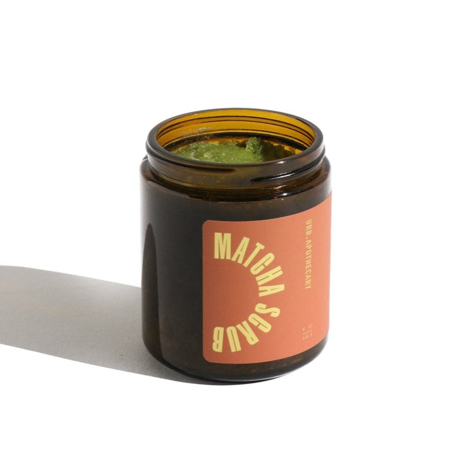 Matcha soap bar in a brown jar with a pink label on a white background